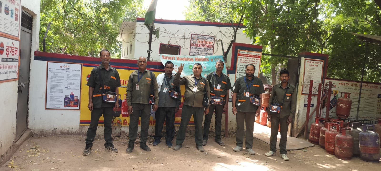 The Indane LPG distribution team with cylinders at the distributor outlet
